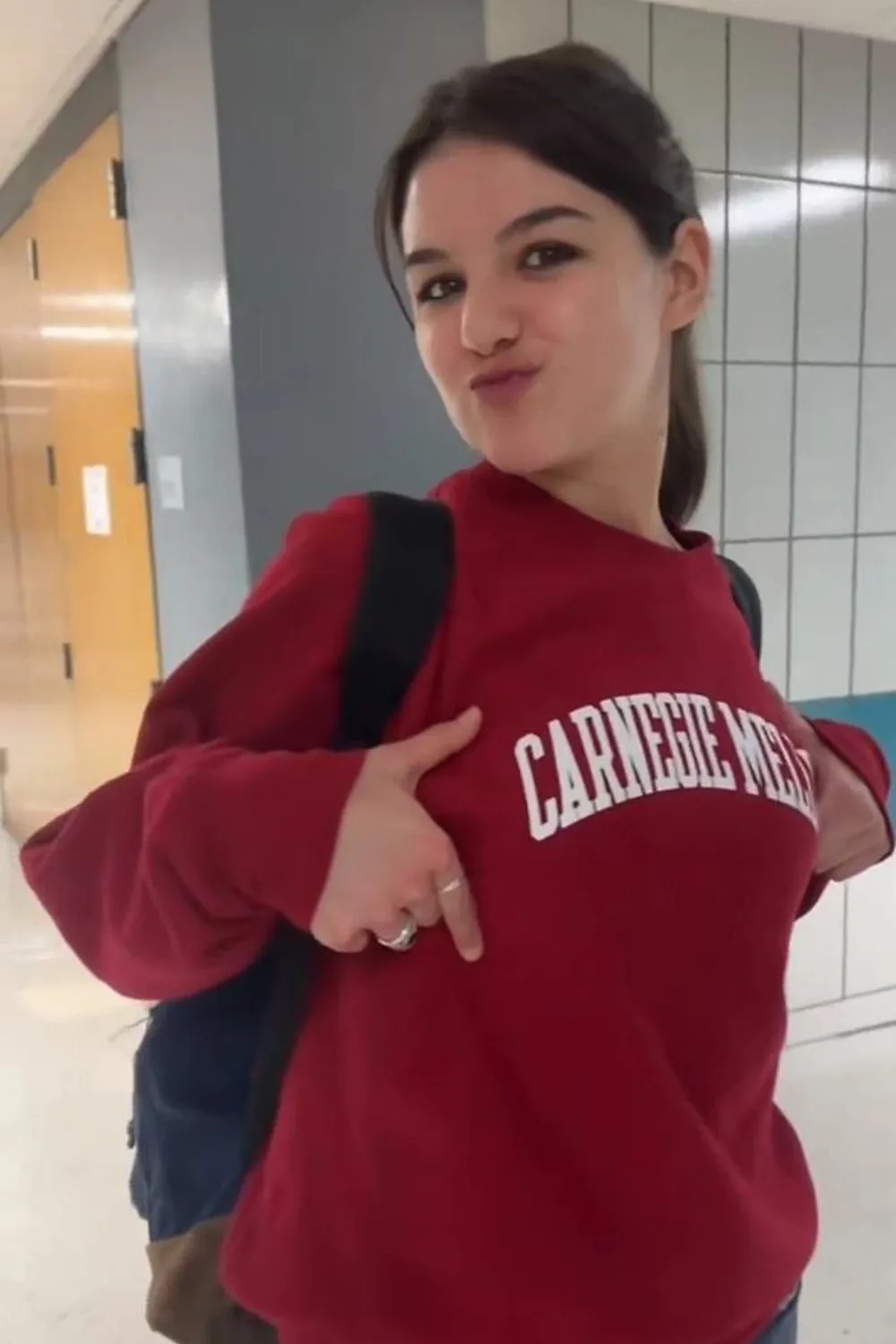 Suri Cruise wearing a red Carnegie Mellon University sweatshirt.