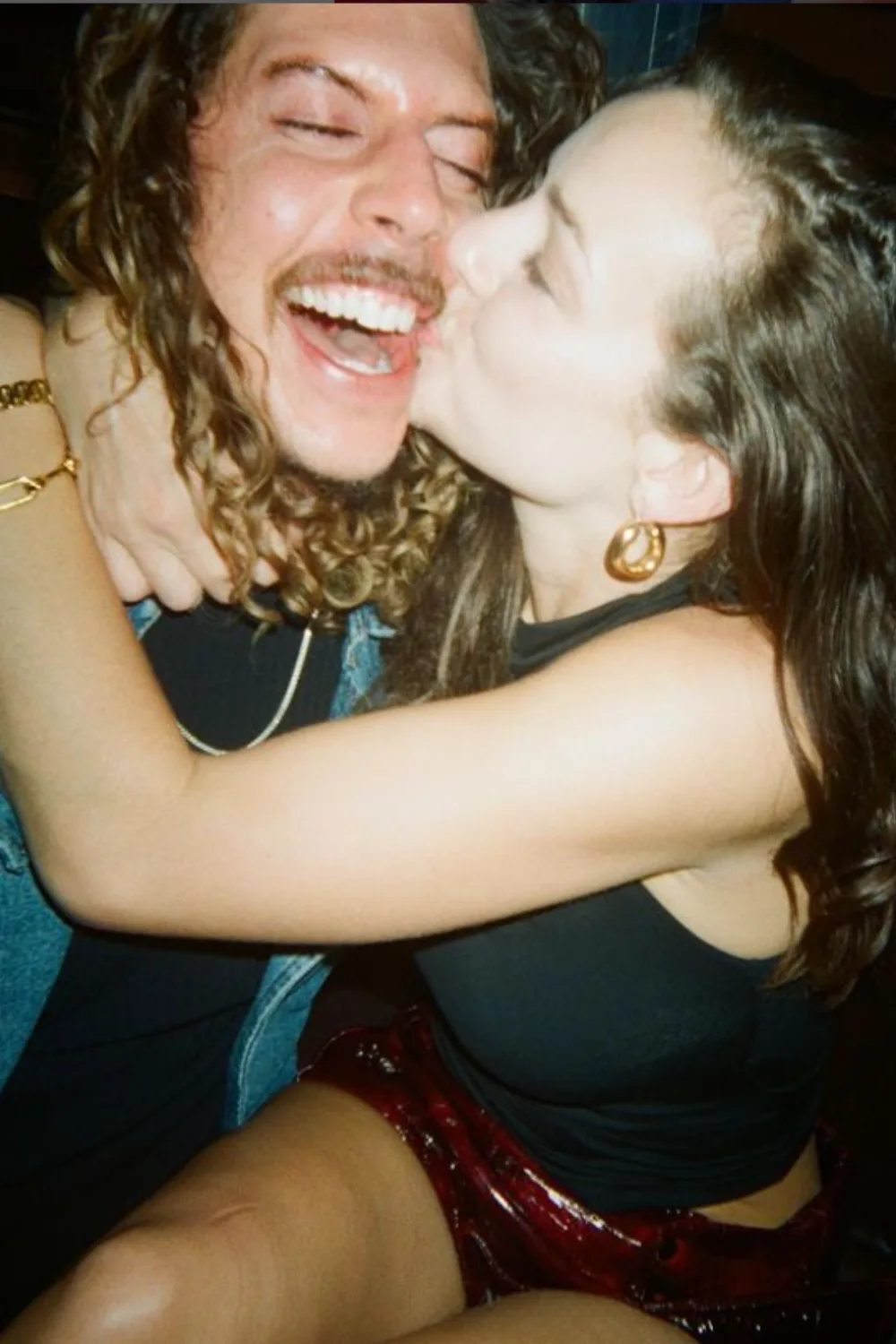 Abbie Chatfield kissing Adam Hyde on the cheek.
