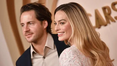 Margot Robbie and Tom Ackerley looking happy on red carpet