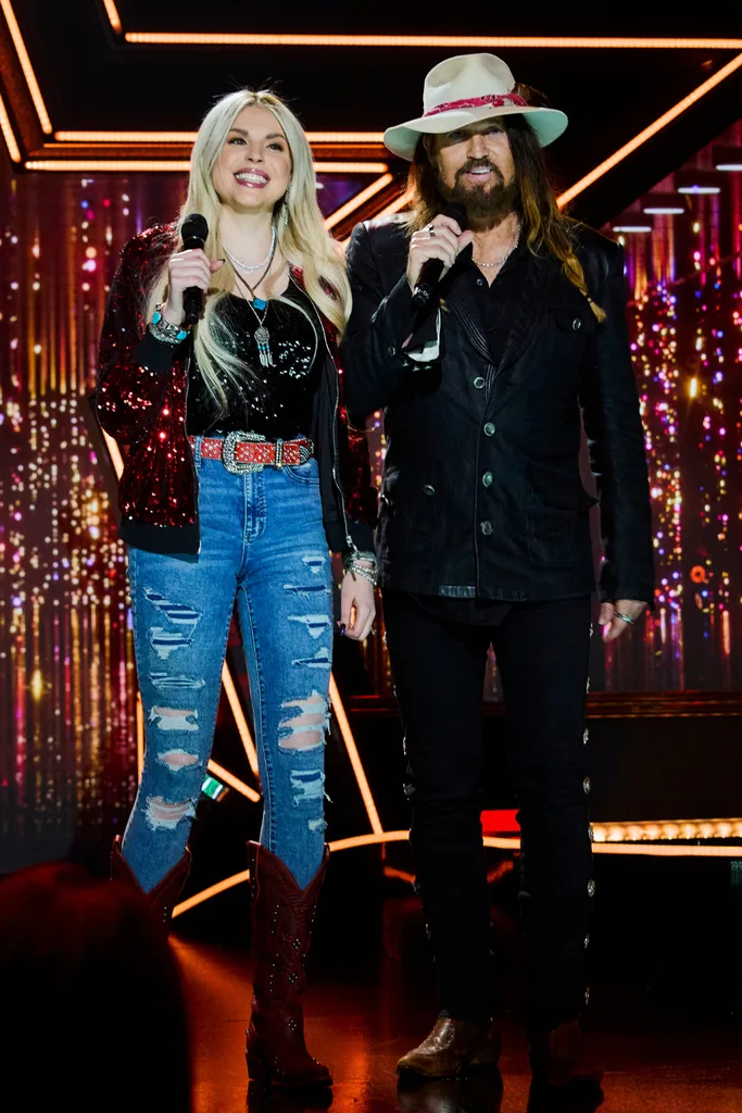Billy Ray Cyrus and Firerose on a stage.