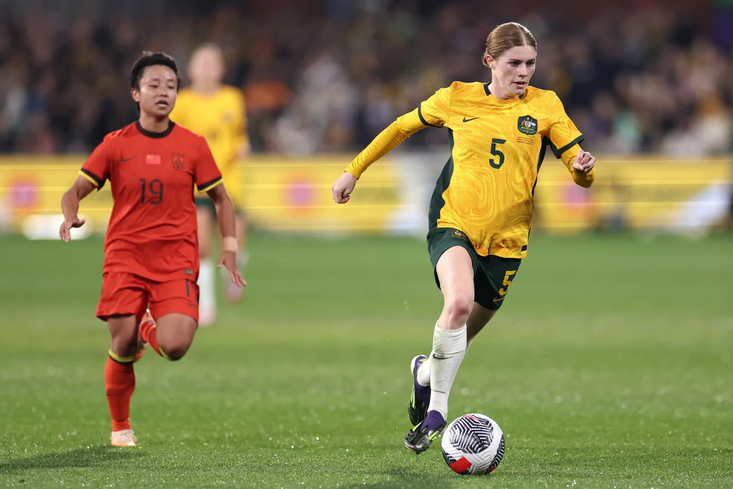 Cortnee Vine kicking a soccer ball.