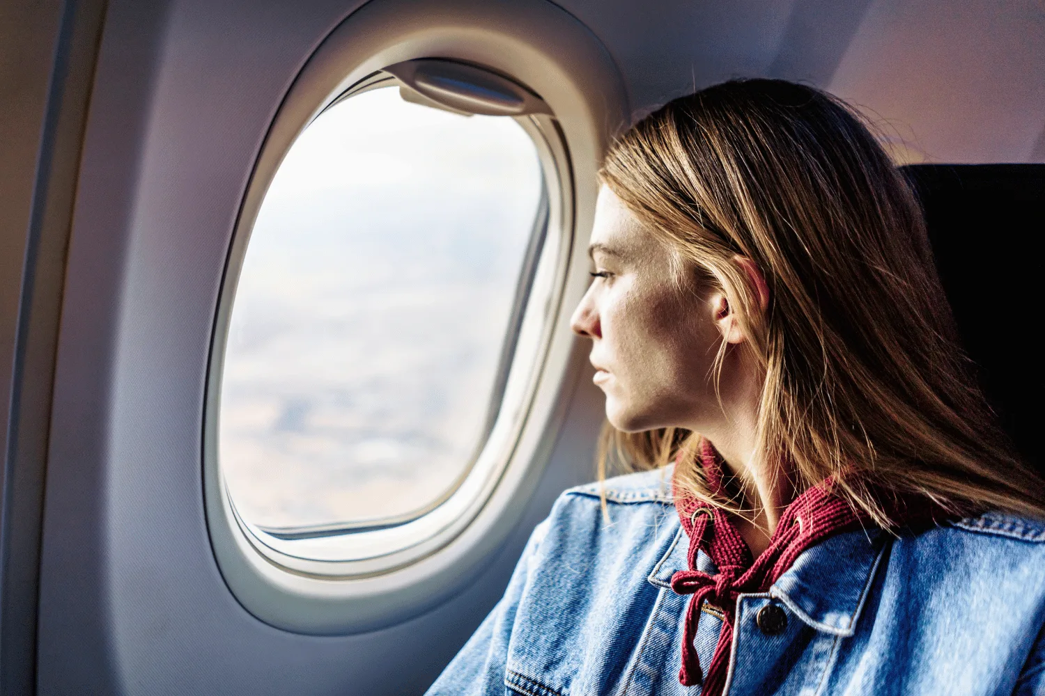 women in plane looking out window
