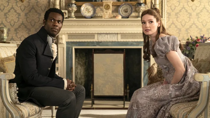 John Stirling and Francesca Bridgerton sitting across from one another in a sitting room.