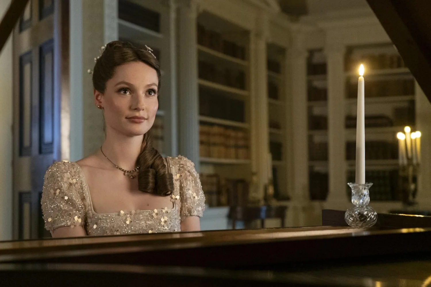 Francesca Bridgerton sitting at a piano.