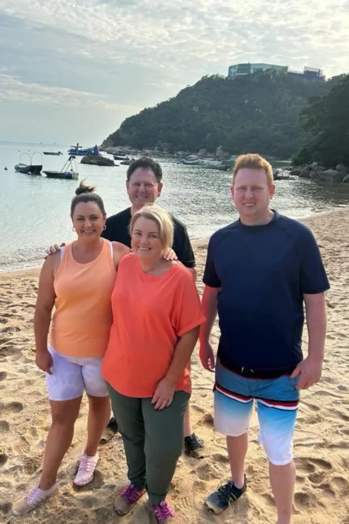 Travel Guides' Fren Family standing on a beach. 