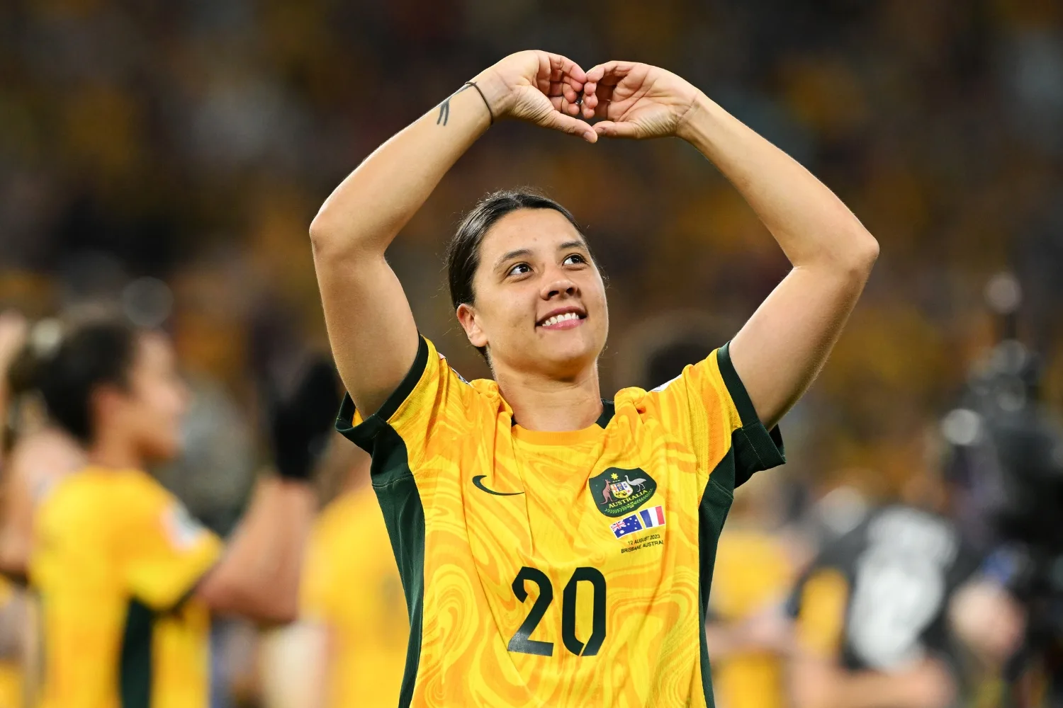 Sam Kerr making a heart with her hands.