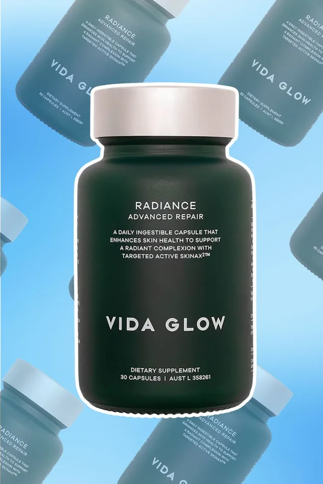 Bottle of Vida Glow Radiance Advanced Repair capsules against a blue background.