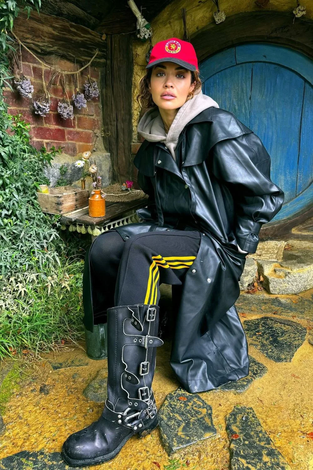 Rita Ora wearing track pants and boots