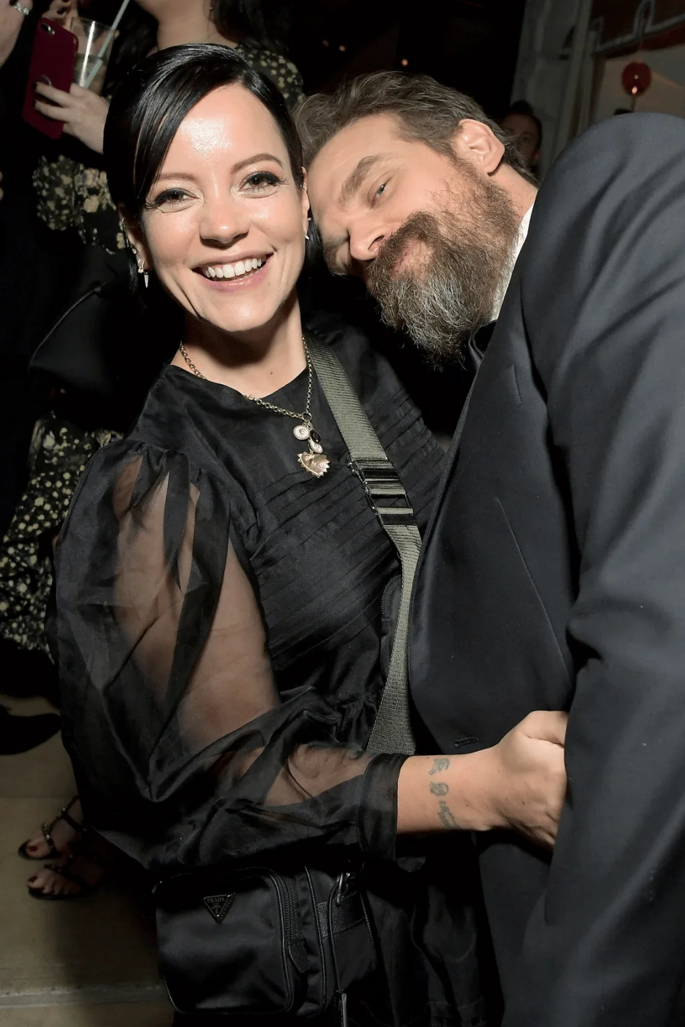 Lily Allen and David Harbour cosying up all in black.