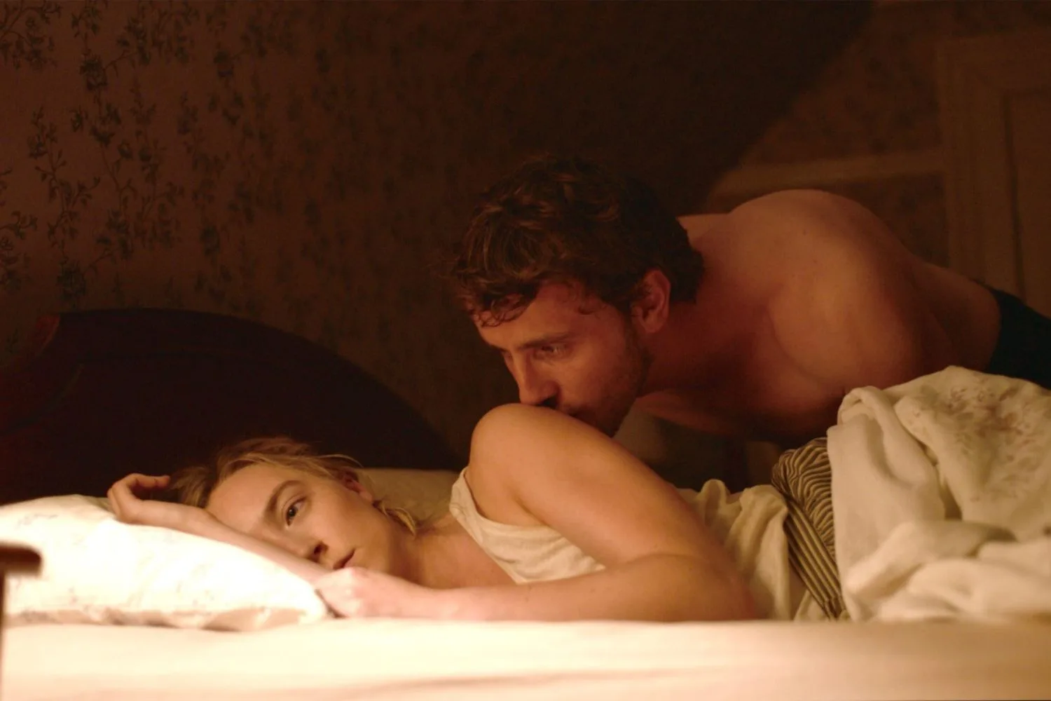 Paul Mescal kissing Saoirse Ronan on the shoulder in Foe 