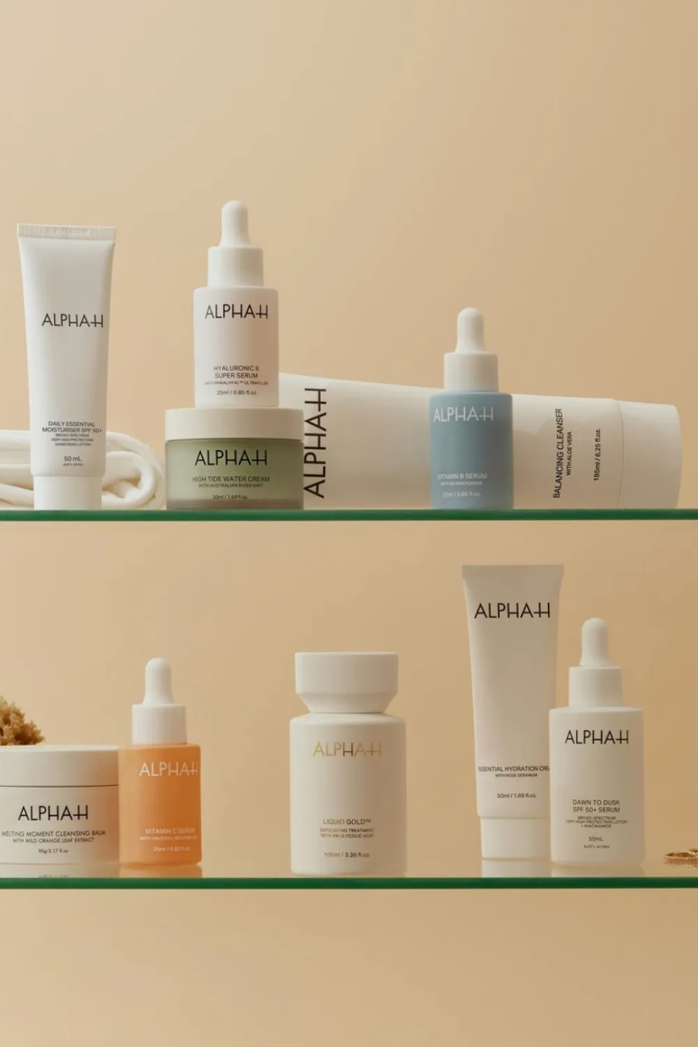 ALPHA-H products scattered across two clear shelves.
