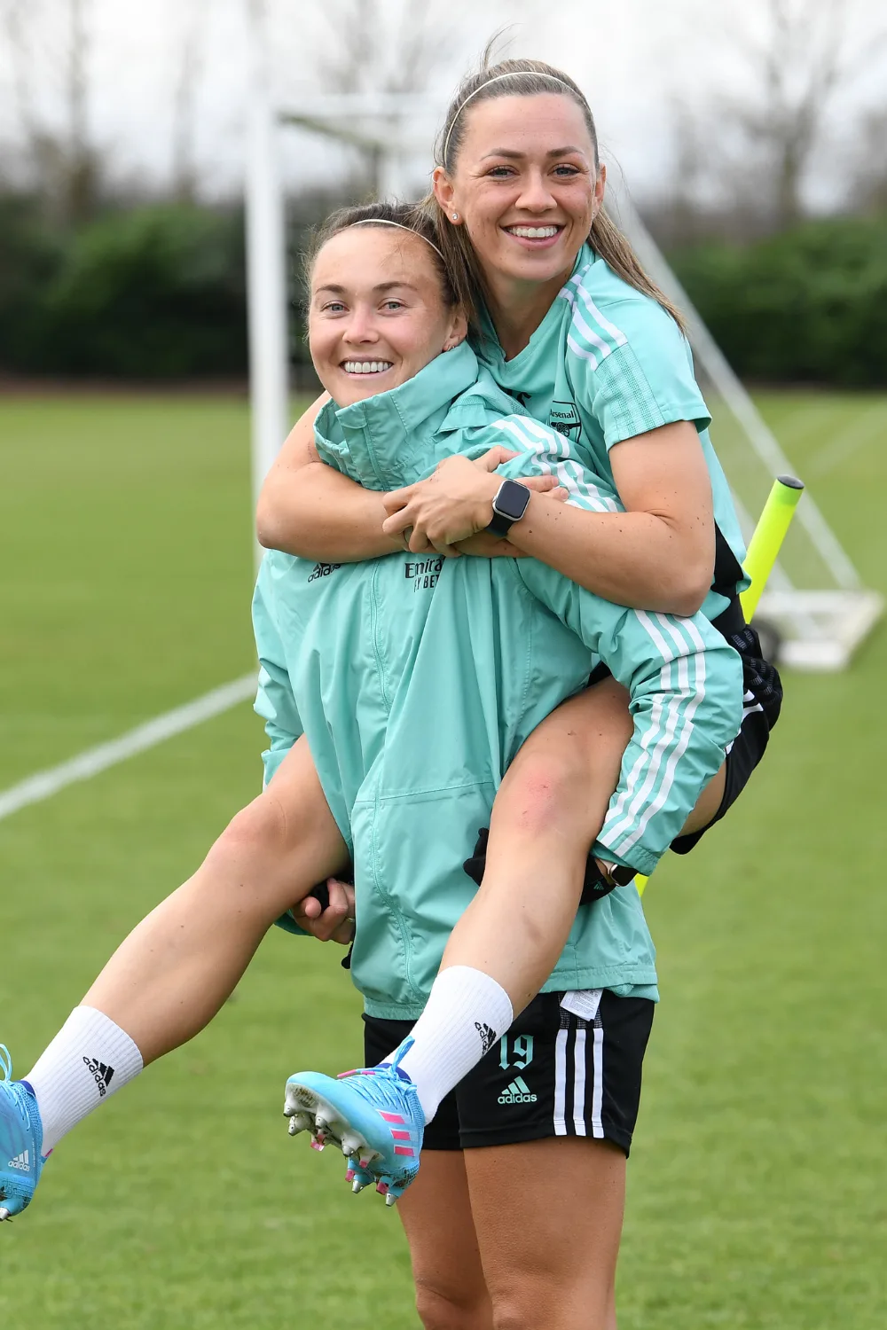 Caitlin Foord giving Katie McCabe a piggyback.