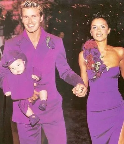 David Beckham and Victoria Beckham wearing purple at their 1999 wedding reception.