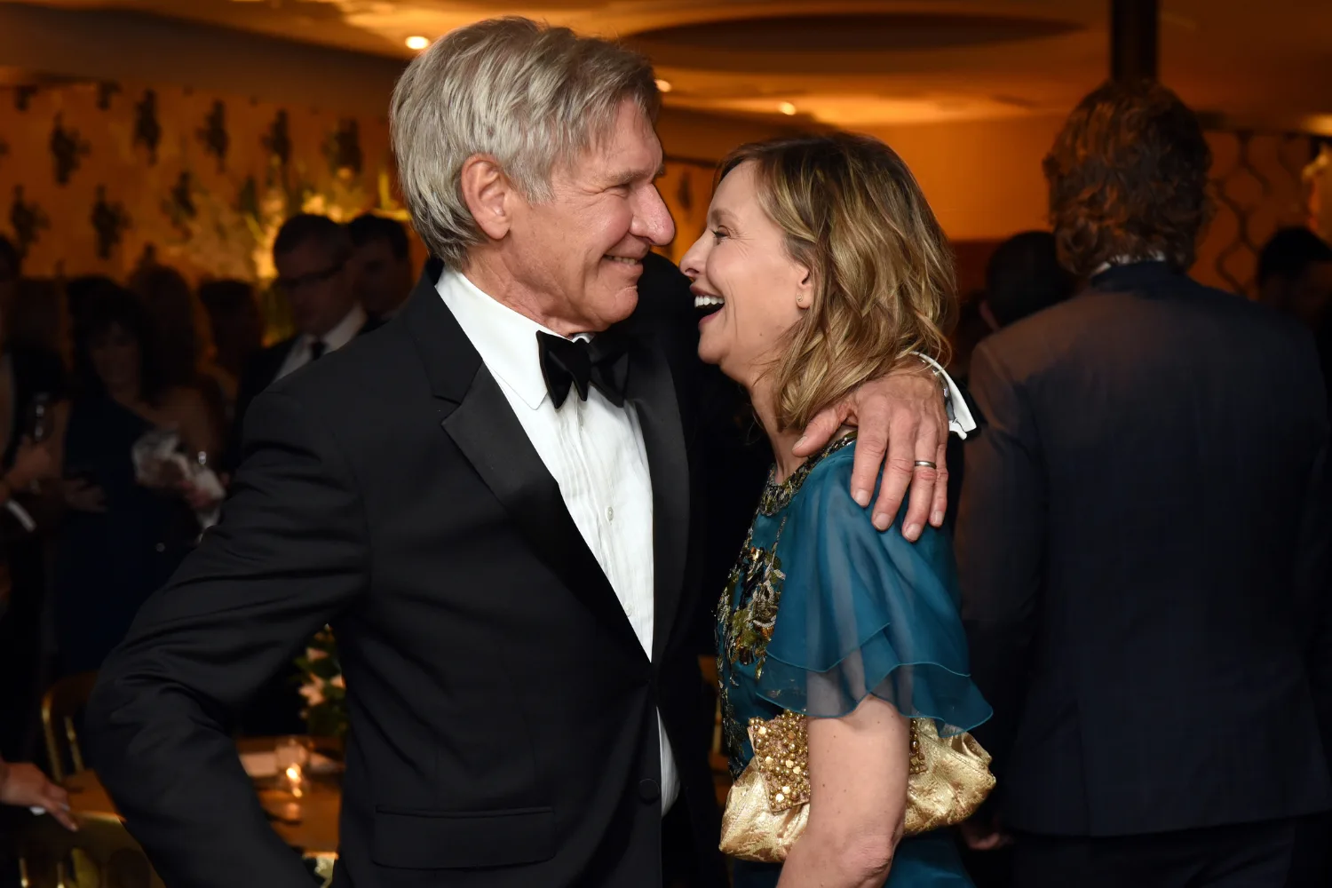 Harrison Ford and Calista Flockhart hugging at an awards show.