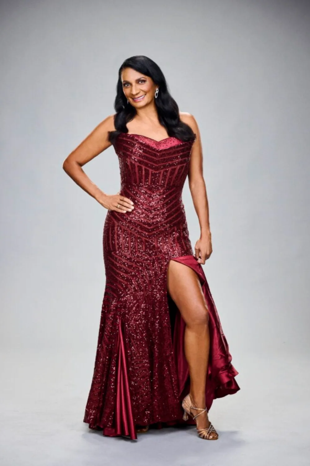 Nova Peris wearing a red dress.
