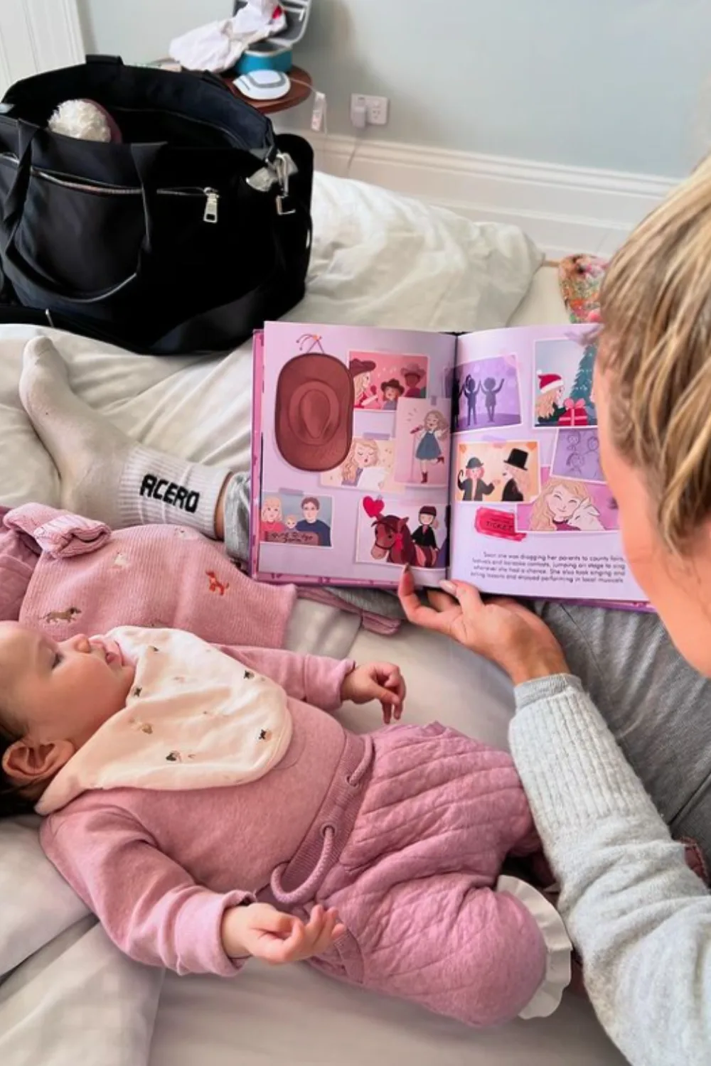 Simone Holtznagel reading a book to her infant daughter.