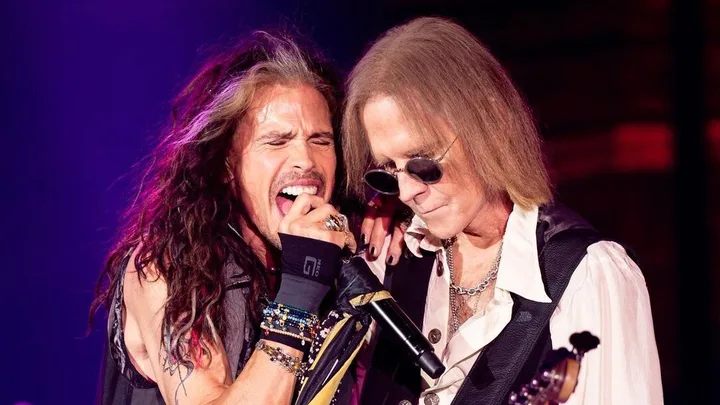 Aerosmith singer Steven Tyler (left) and bassist Tom Hamilton performing live.