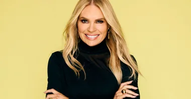 Sonia Kruger black dress yellow background.