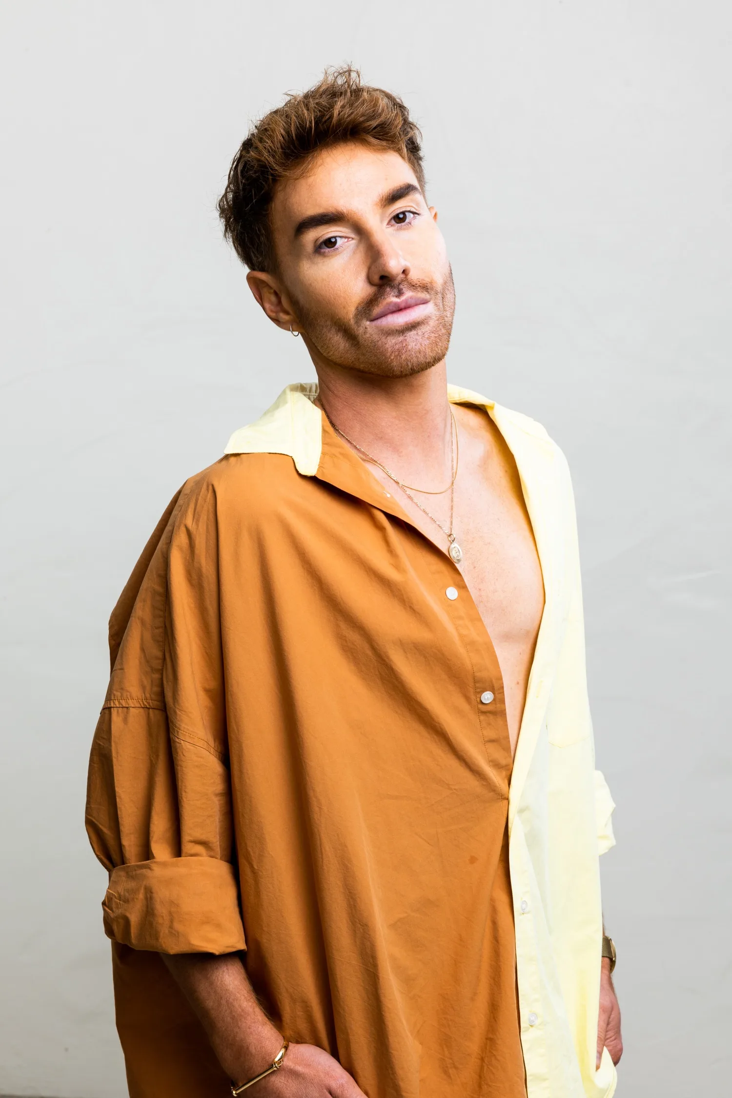 Billy Daniels from Made In Bondi poses in an unbuttoned shirt.