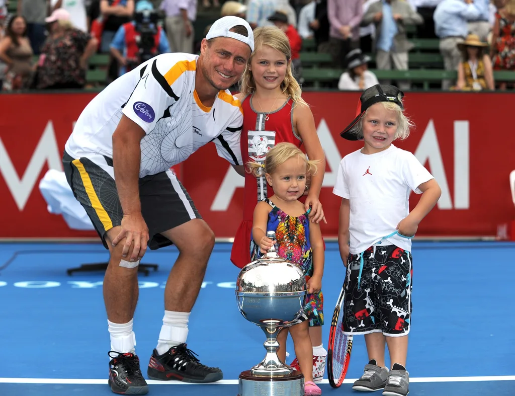Lleyton Hewitt and his kids Mia, Cruz, and Ava and the winners trophy after he defeated Juan Martin Del Potro of Argentina in the final match of the Kooyong Clasic tournament Melbourne, Saturday, Jan. 12, 2013.