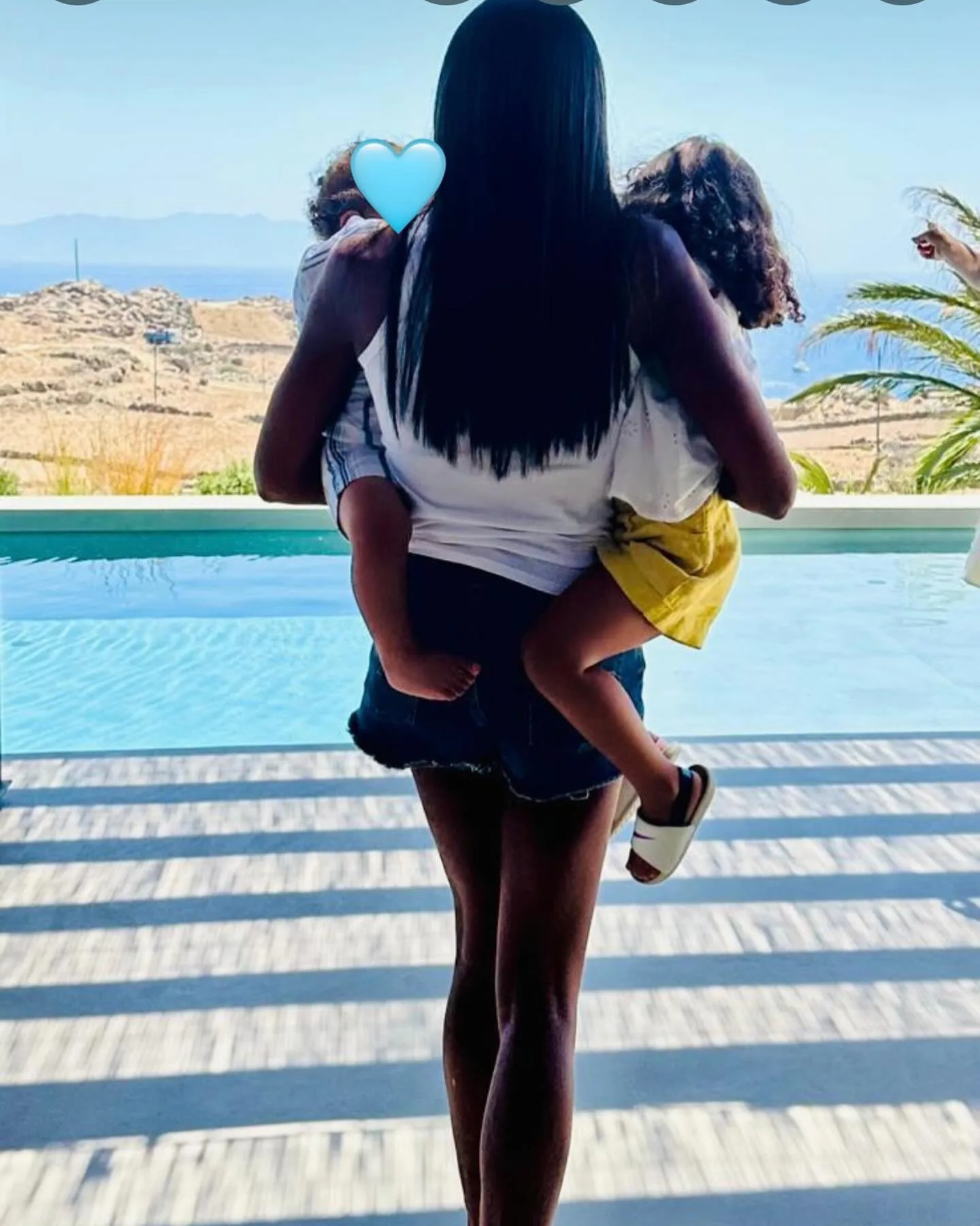 Naomi Campbell balances her two children on her hip in a photo shared to Instagram