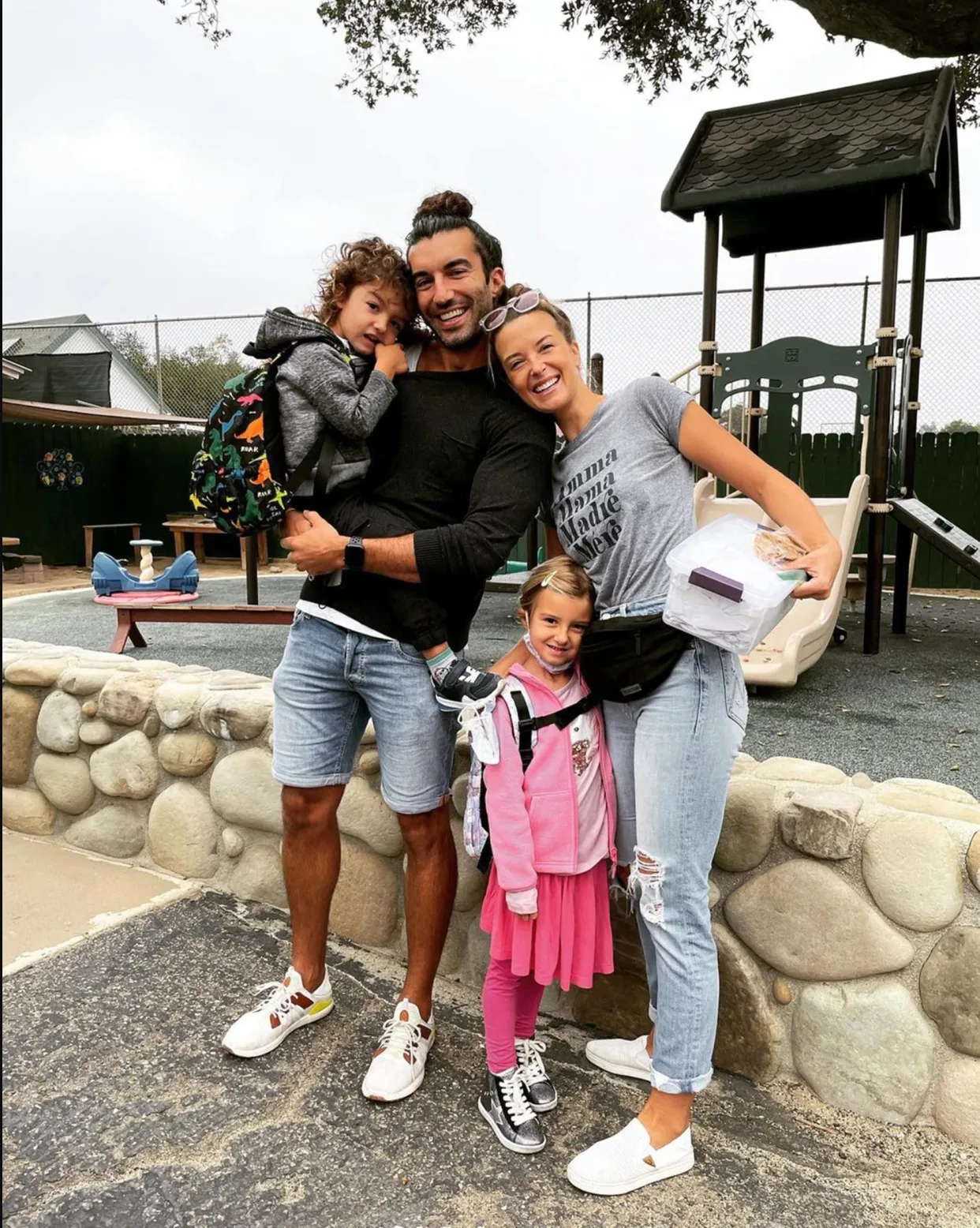Justin and Emily Baldoni with their two children at a playground.