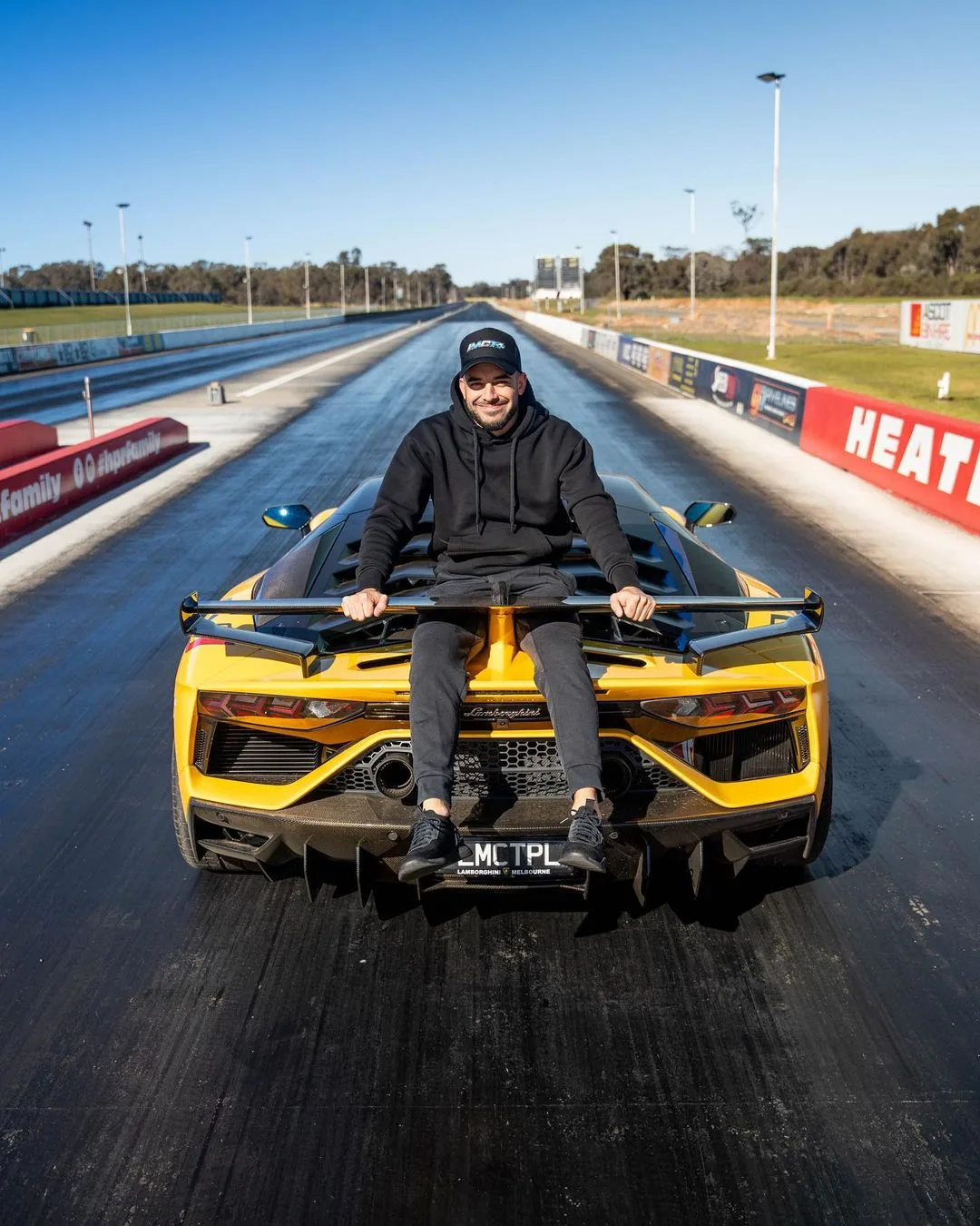 Adrian Portelli with a  yellow Lamborghini