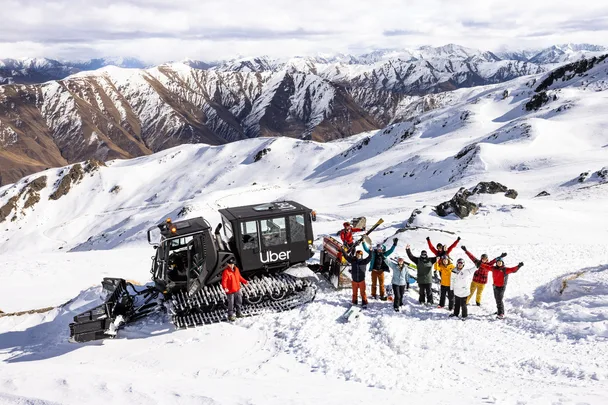 Skiers stand around an Uber snowcat at Soho Basin