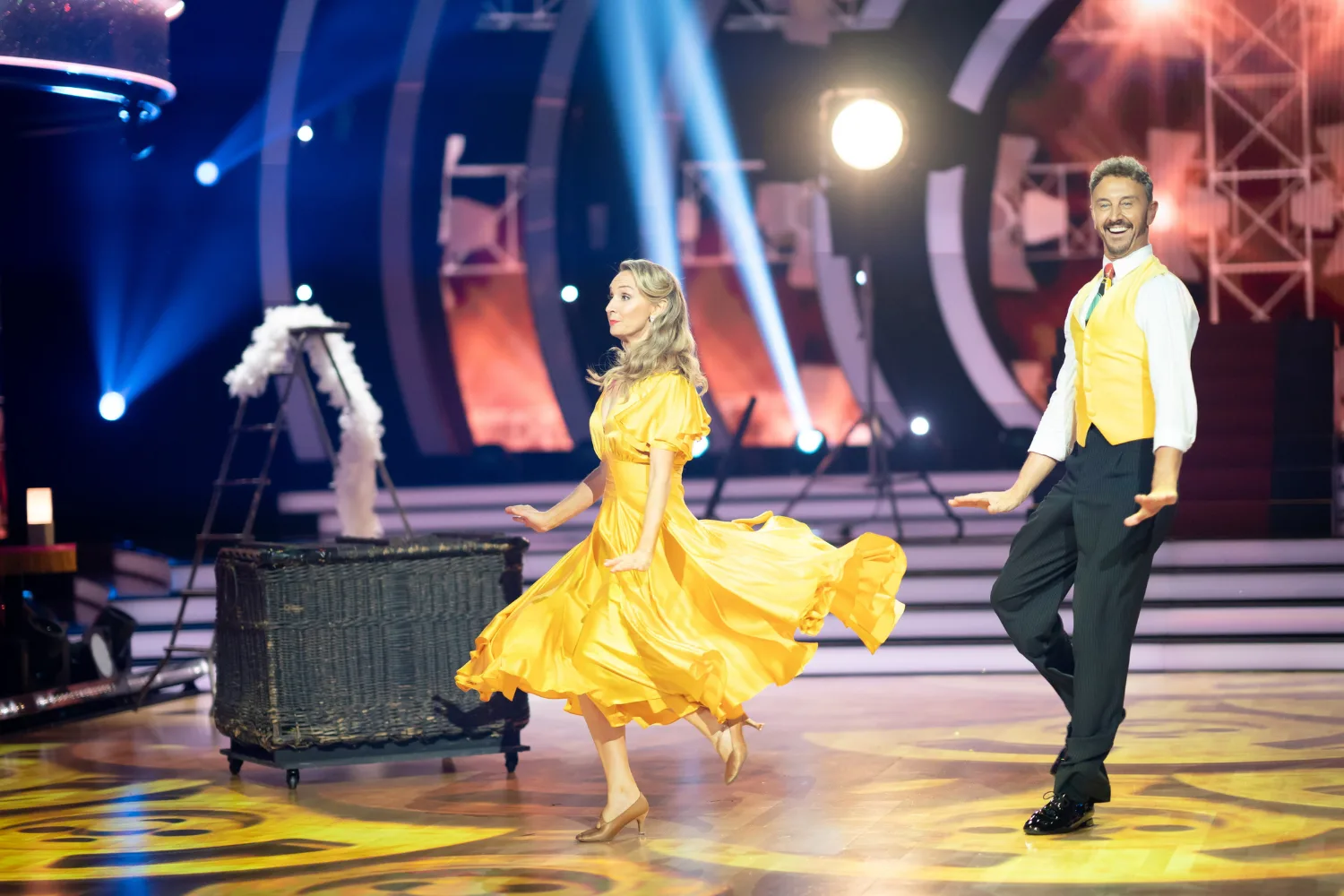 Lisa McCune dancing in a yellow dress for the Dancing with the Stars finale. 