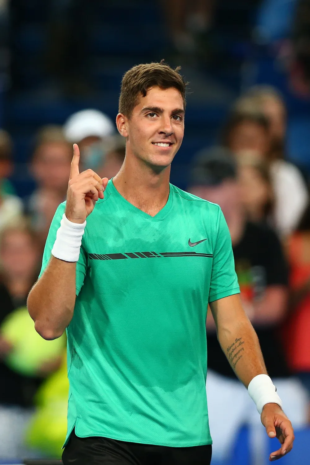 thanasi kokkinakis wearing a green shirt