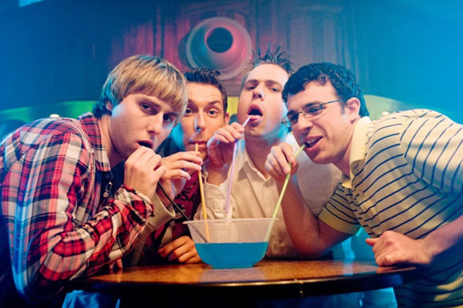 The four members of The Inbetweeners drinking out of one cocktail jug.