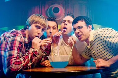 The four members of The Inbetweeners drinking out of one cocktail jug.