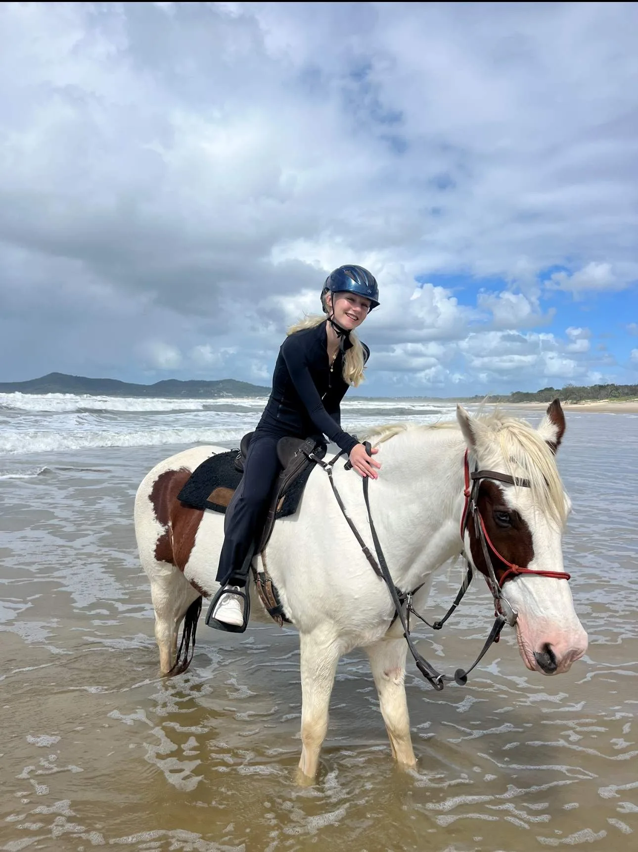 Allegra Overton rides a horse in the surf