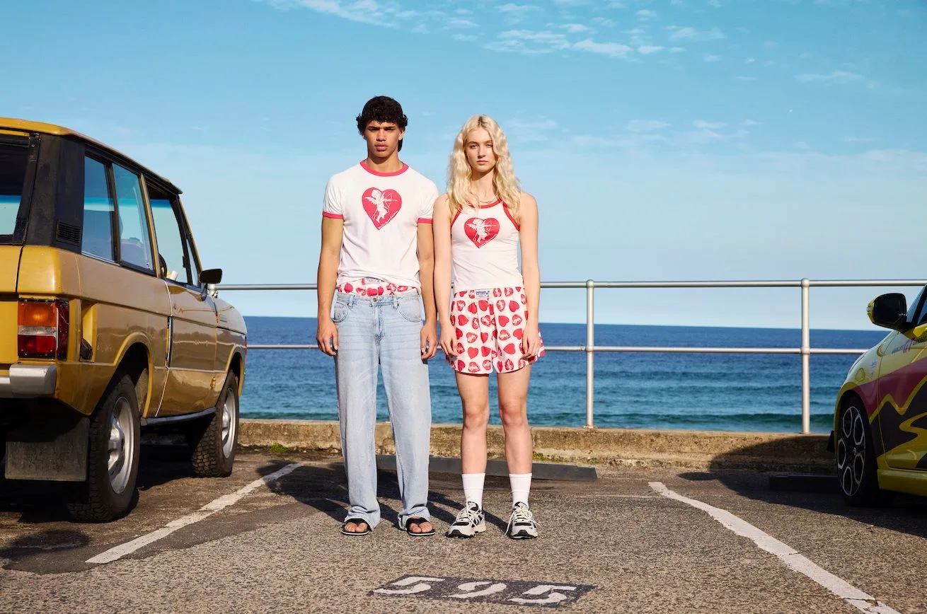 Allegra Overton and a male model stand in a carpark in a shoot for Bonds