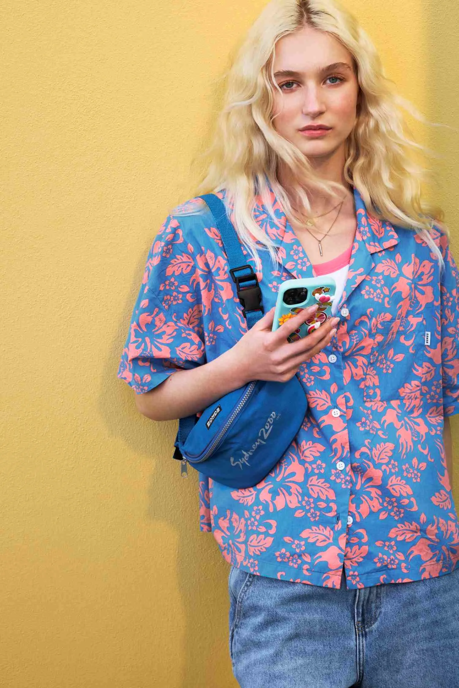 Allegra Overton holds a phone in a modelling shot
