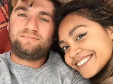 Jessica Mauboy and her husband lying together on a rug