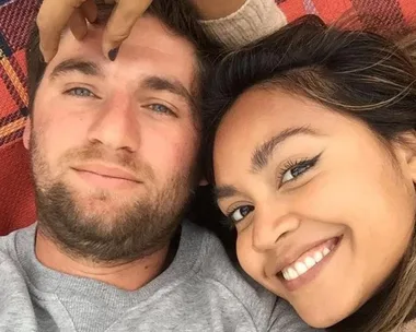 Jessica Mauboy and her husband lying together on a rug