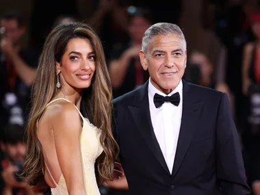 VENICE, ITALY - SEPTEMBER 01: Amal Clooney and George Clooney attend the "Wolfs" red carpet during the 81st Venice International Film Festival on September 01, 2024 in Venice, Italy. (Photo by Maria Moratti/Getty Images)