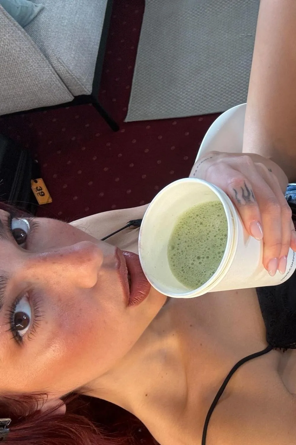 Dua Lipa drinking a matcha latte