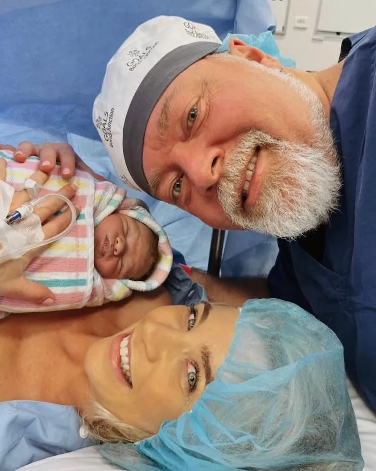 Kyle Sandilands and Tegan Kynaston holding baby Otto after her c-section.