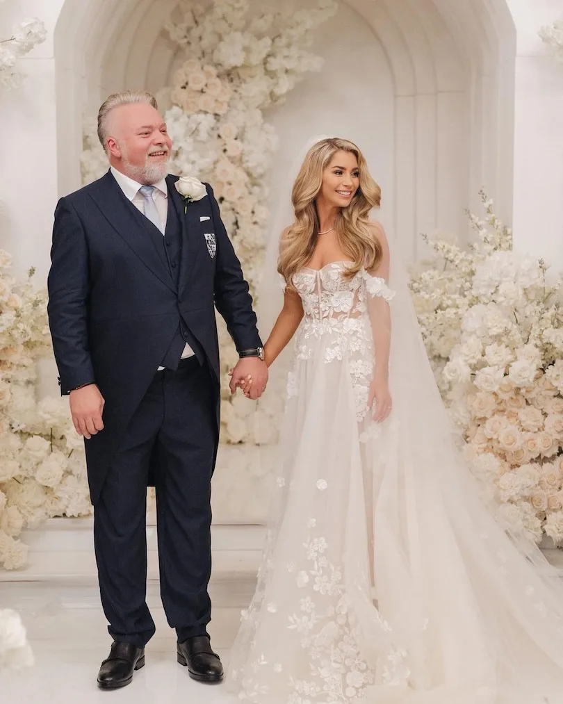 Kyle Sandilands and Tegan Kynaston in bridal wear on their wedding day.