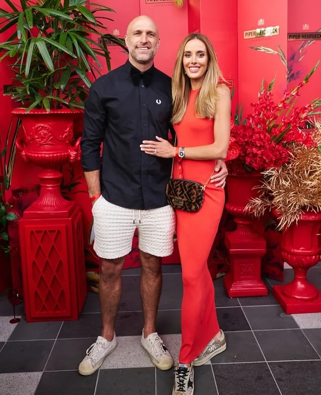 Chris and Bec Judd with their arms around each other.