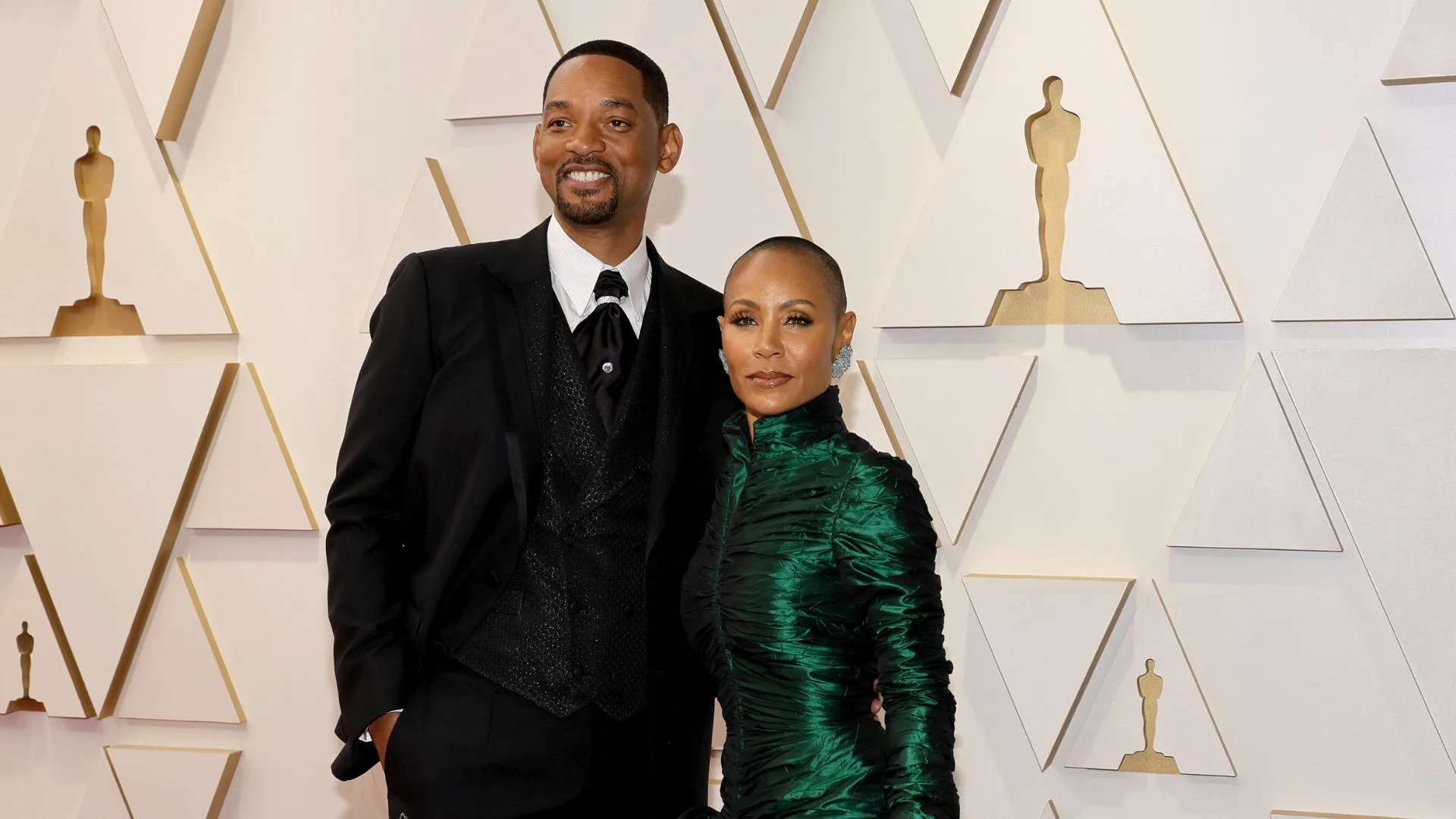 Will Smith and Jada Pinkett Smith with arms around each other