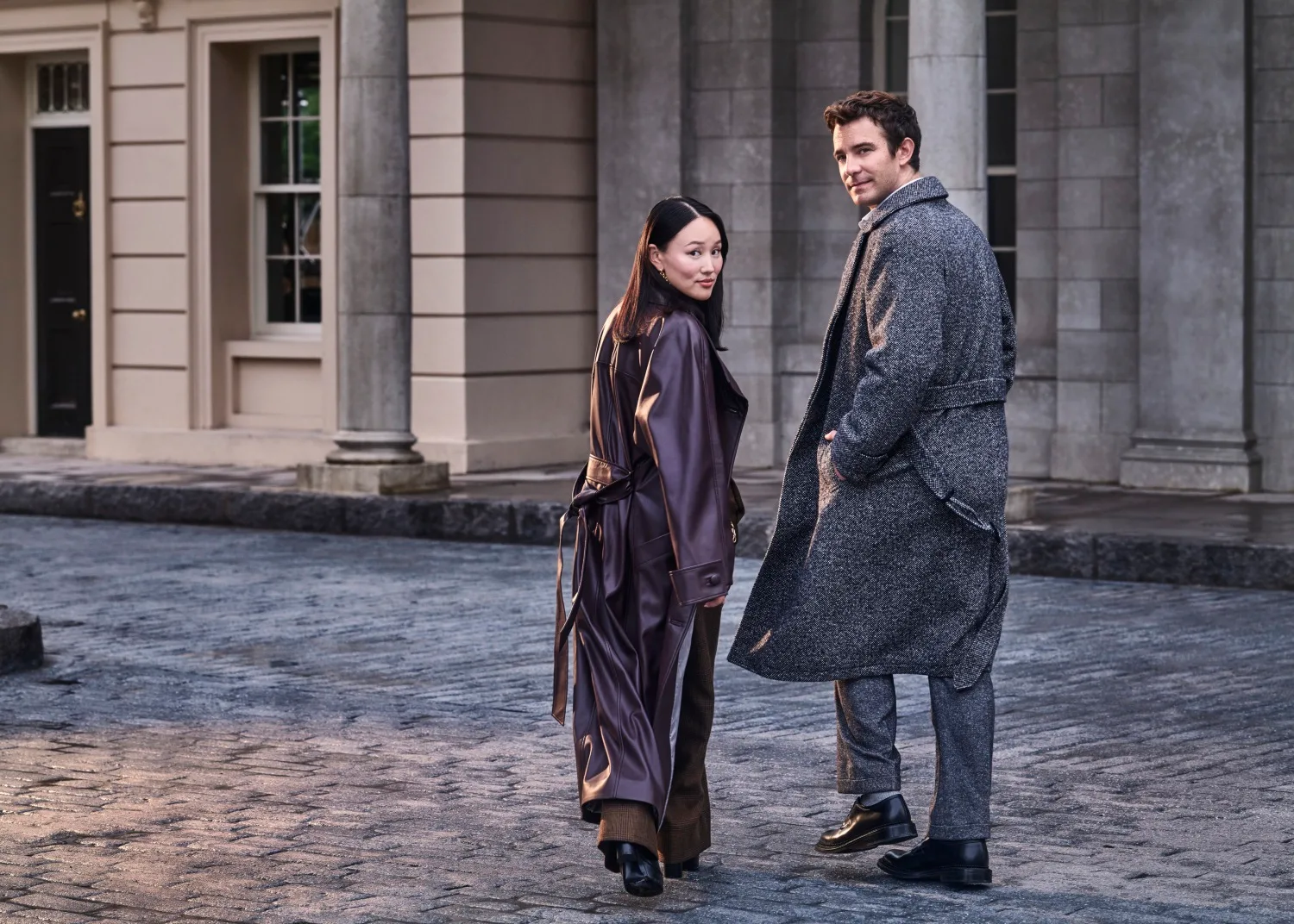 Yerin Ha and Luke Thompson walk together on the set of Bridgerton