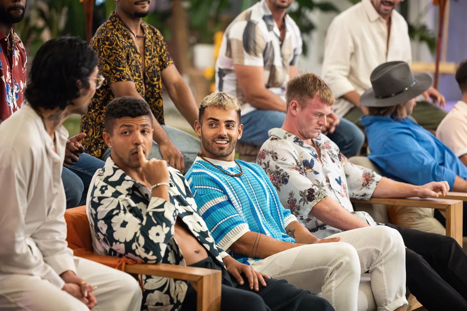 FBoy Island Nathan sitting among a group of male contestants.