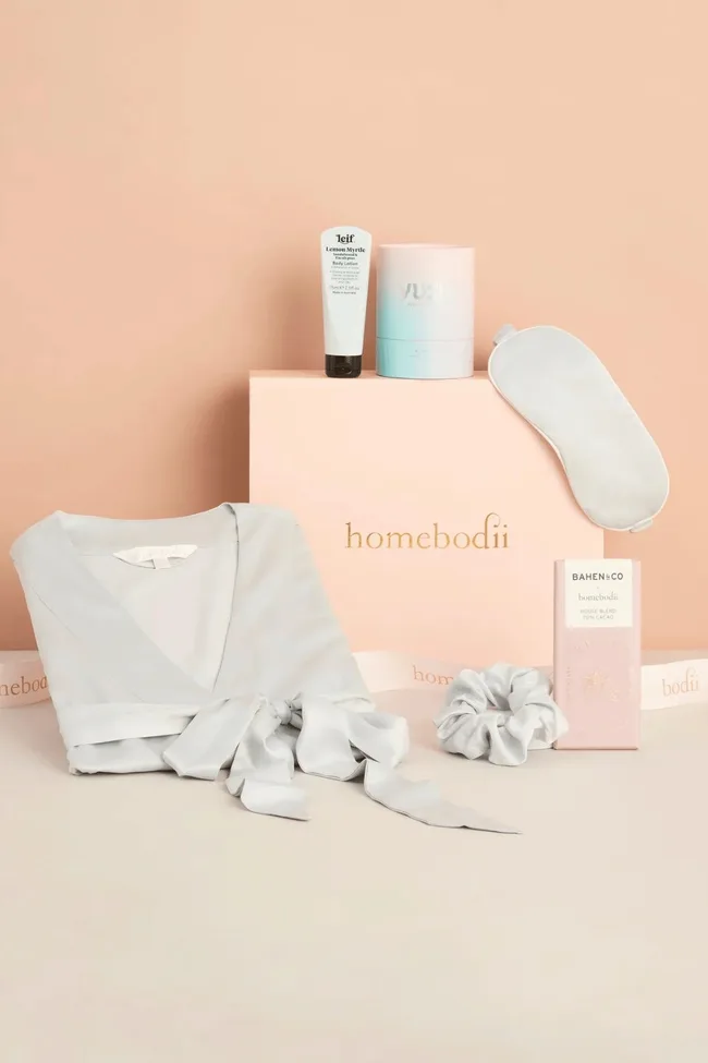 A grey bridesmaid hamper on a pink backdrop.