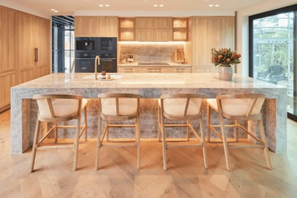 A light wood kitchen with pink marble countertop