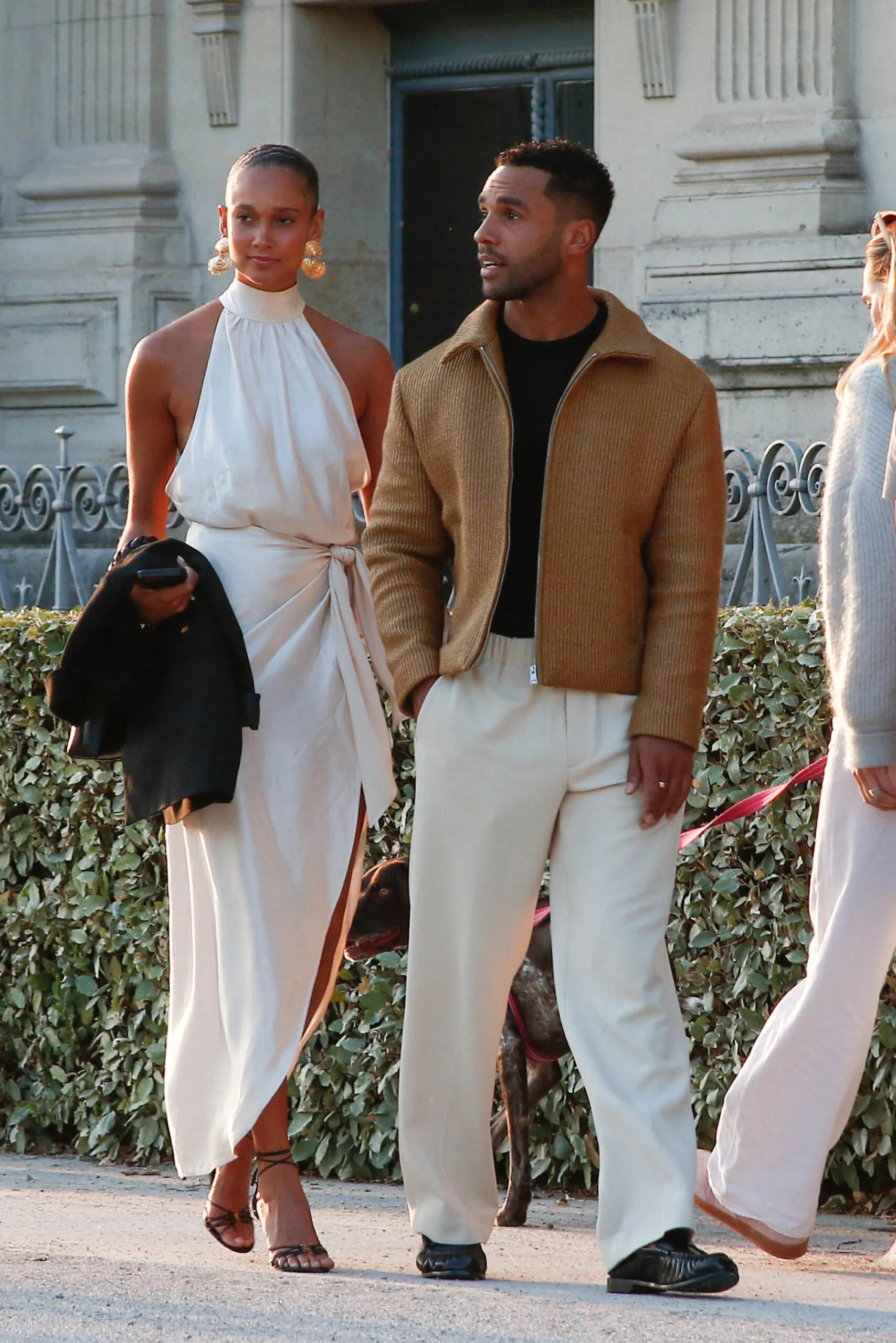 lucien laviscount and woman in white dress and heels walking in paris