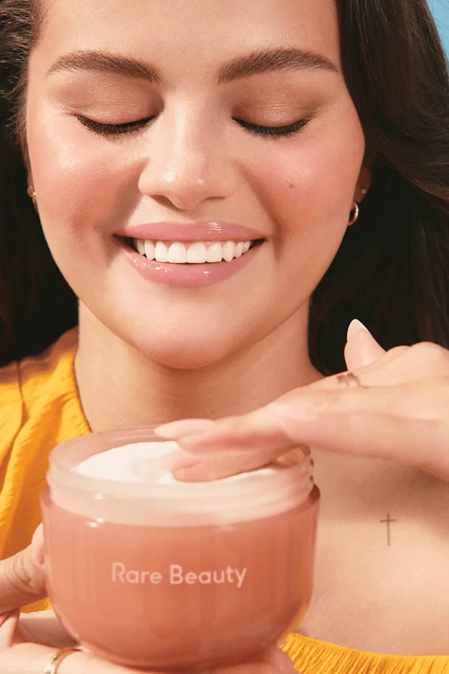 Selena Gomez holding the rare beauty body cream