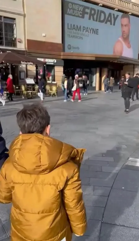 Liam Payne son bear staring at a billboard of his dad